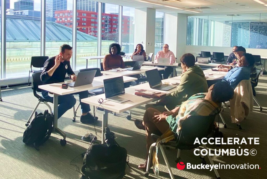 Brad Griffith teaches Accelerate Columbus students in a conference room.