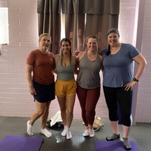 four women posing for a photo after a pilates class