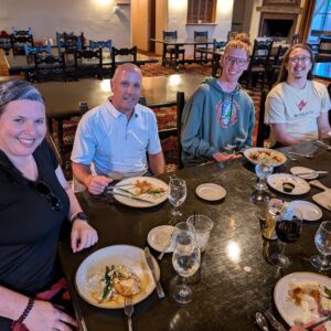 4 people smiling at a table