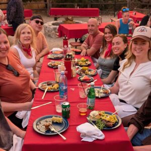 Buckeye Innovation team members sitting around a table enjoying a meal outdoors