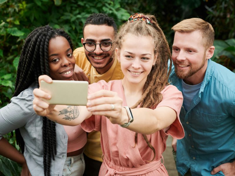 A group of 4 people take a selfie