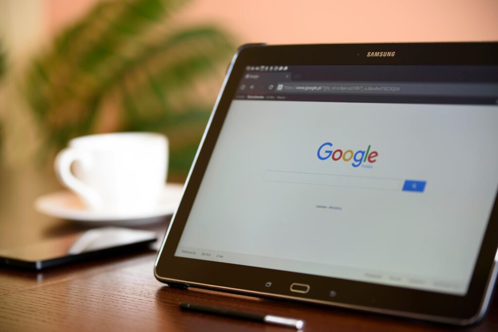 tablet with tab opened to Google, with a coffee cup in the background